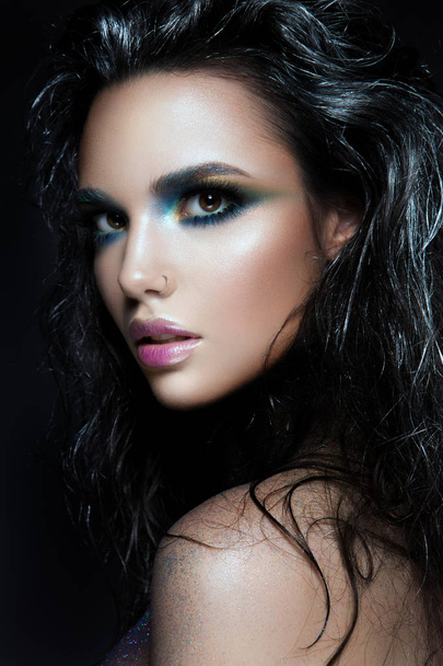 Beautyful girl with blue glitter on her face - Фото, изображение