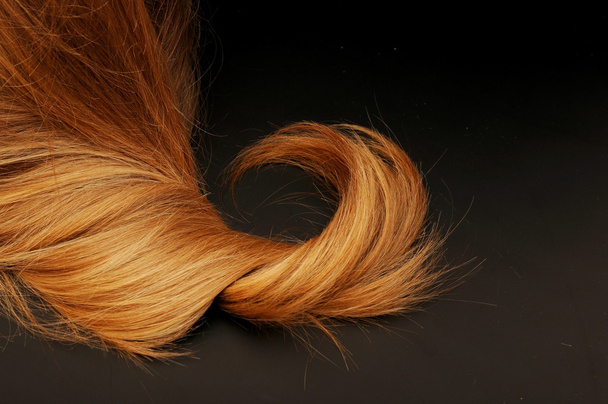 Blond hair isolated on black - Photo, Image