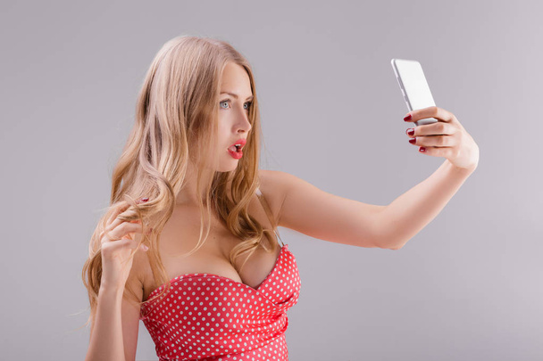 blond woman makes selfie on phone - Foto, immagini