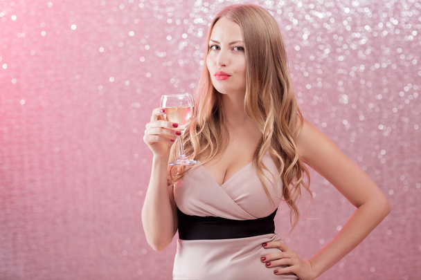 sexy blond woman with a glass of champagne at party - Фото, изображение