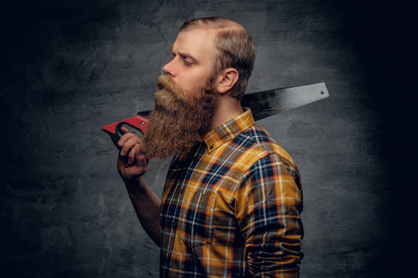 Bearded carpenter in a plaid shirt  - Fotoğraf, Görsel