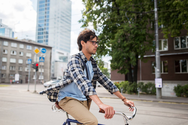 young hipster man with bag riding fixed gear bike - Foto, Imagem