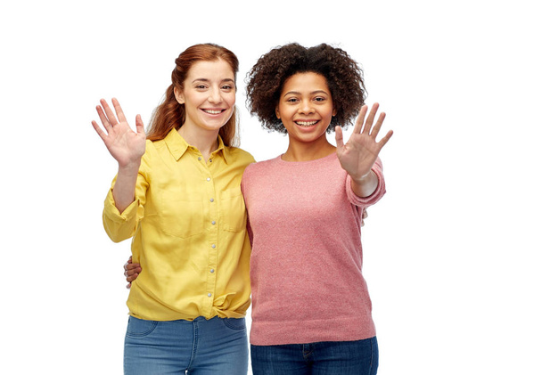 happy smiling women waving hands over white - Foto, afbeelding