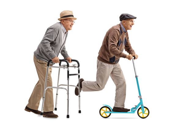 Senior walking with a walker and another senior riding a scooter - Фото, изображение
