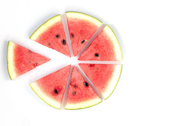 Watermelon slices arranged on a white background - Фото, зображення