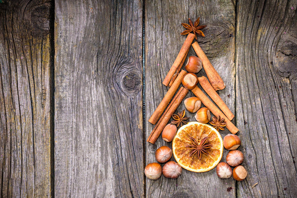 Новорічна ялинка з горіхів, спецій та сушених апельсинів
. - Фото, зображення
