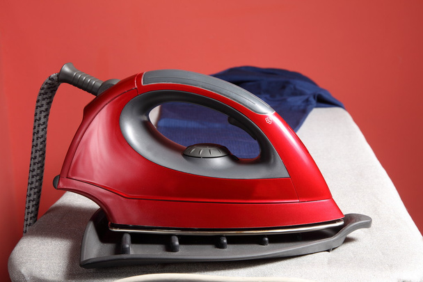 Household chores - red iron and navy blue shirt - Zdjęcie, obraz