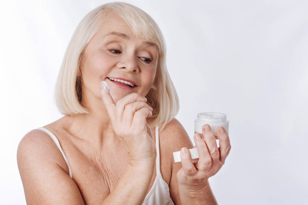 woman putting anti age cream - Foto, immagini