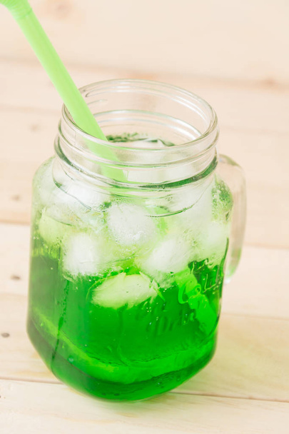 green soda on wood background - Foto, Imagen