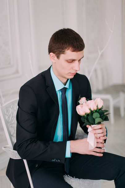 Full body portrait of young stylish businessman in tie and vest with hands on waist - Фото, зображення