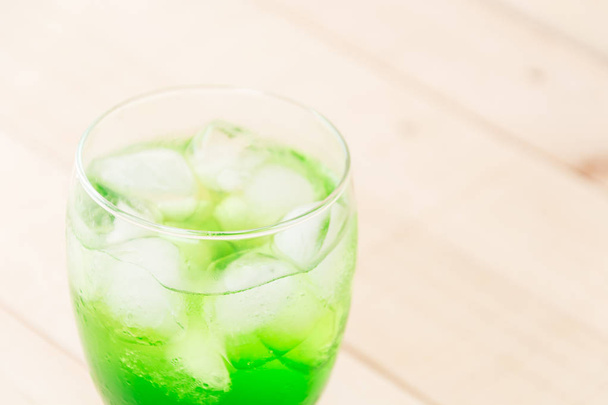 green soda on wood background - Photo, Image