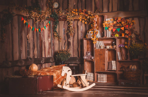autumn decor in the Studio with a horse-rocking chair - Photo, Image