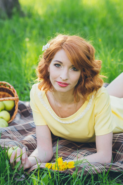 Beautiful sensual woman with red hair in spring garden - Fotoğraf, Görsel