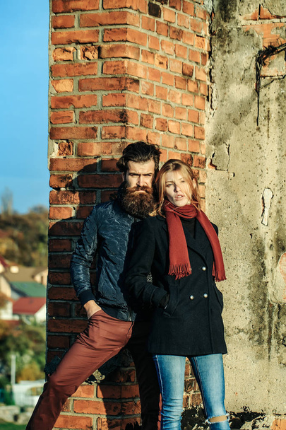Young couple near roof brick wall - 写真・画像