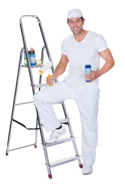 Painter Holding A Paint Roller And Paint Bottle - Foto, imagen