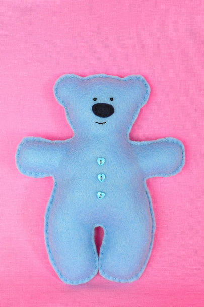 Ручной войлочный медведь - синий войлочный медведь на розовом фоне, игрушка ручной работы, ремесло из войлока
 - Фото, изображение