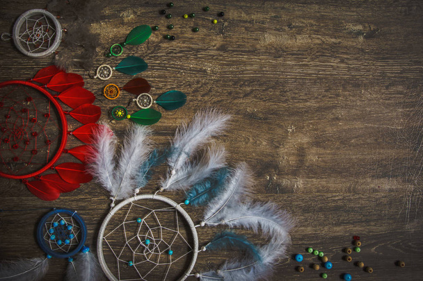 Dream catcher feathers on a dark wooden background, pheasant feathers, duck feathers, chicken feathers - Foto, Imagem
