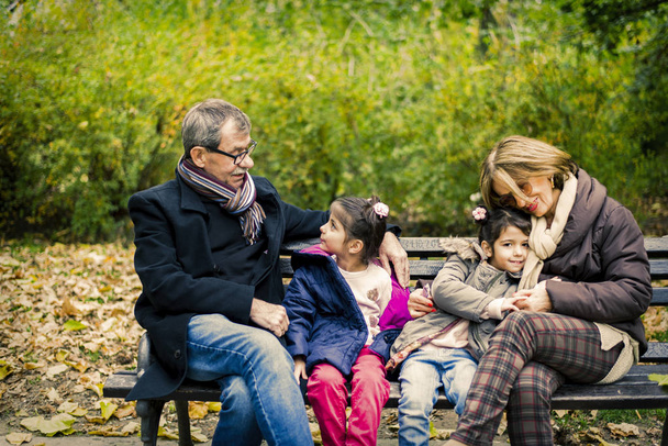 Grandparents with grandchildren in autumn park - Photo, Image