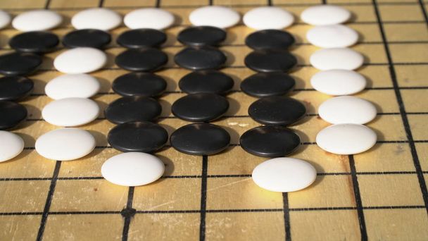 Chinese Go or Weiqi board game. Atari position with group. Outside activity - Photo, Image