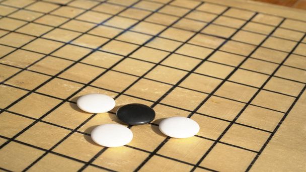 Chinese Go or Weiqi board game. Go ttitle with black and white stones. Outside activity - Photo, Image