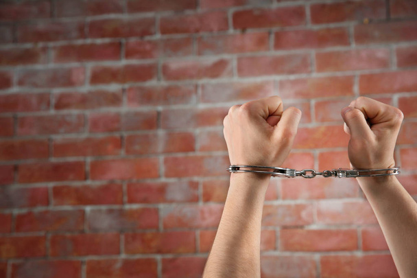 Man hands in handcuffs - Φωτογραφία, εικόνα