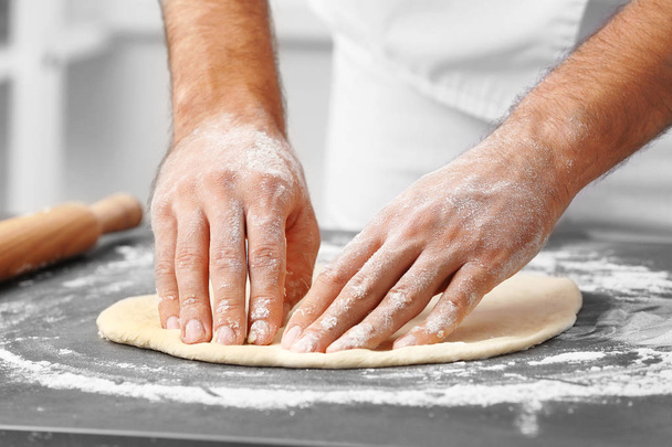 Male hands preparing dough for pizza - Фото, зображення