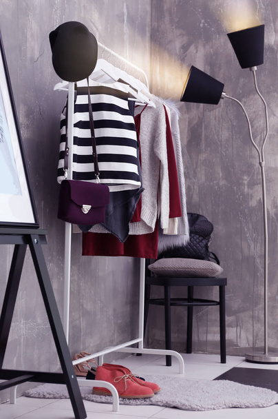 Fashionable clothes hanging on rack  - Photo, Image