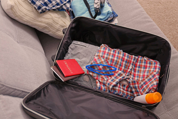 Open suitcase with clothes  - Valokuva, kuva