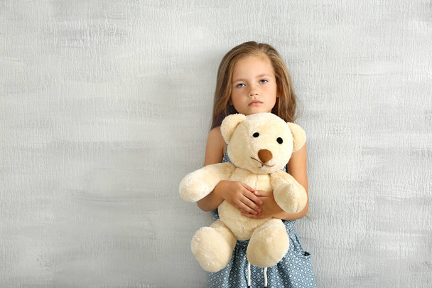 Cute little girl with teddy bear   - Фото, изображение