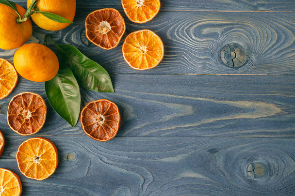 Dried orange slices on a blue wooden table - Fotoğraf, Görsel