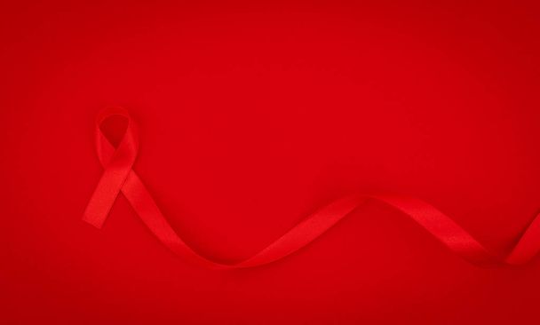 Aids Awareness Red heart Ribbon on red background . - Zdjęcie, obraz