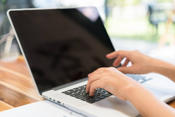 Closeup of business woman hand typing on laptop keyboard . - Фото, изображение