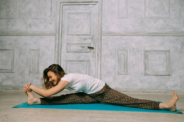 Young woman practicing in a yoga studio.  - Foto, Imagen