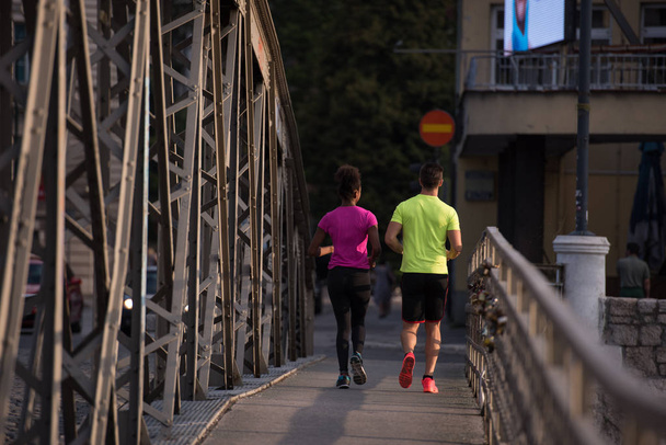 multiethnic couple jogging in the city - Foto, imagen