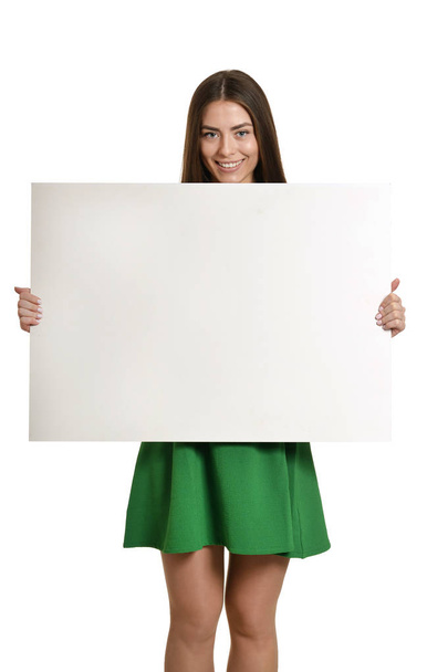 young girl with empty sheet of paper - Фото, изображение