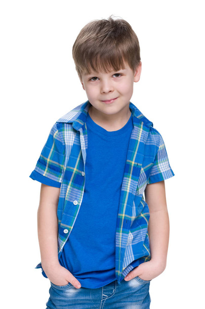 Fashion young boy is standing against the white - Photo, image