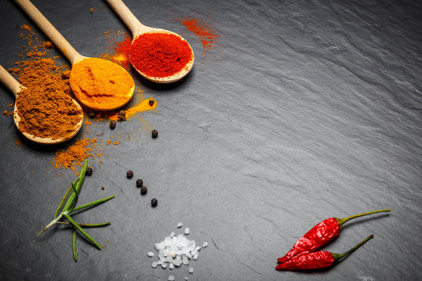 spices and herbs over black stone background, top view with copy space - Foto, Imagen