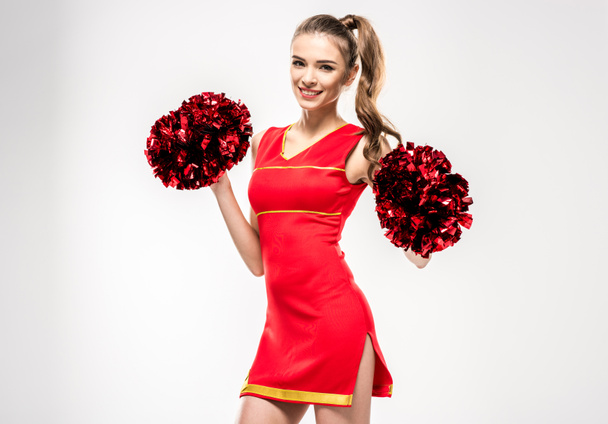 Cheerleader posing with pom-poms - Foto, afbeelding