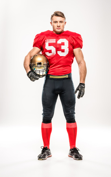 Football player holding helmet - Valokuva, kuva