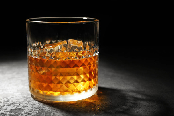 Glass of whisky on   table  - Foto, imagen
