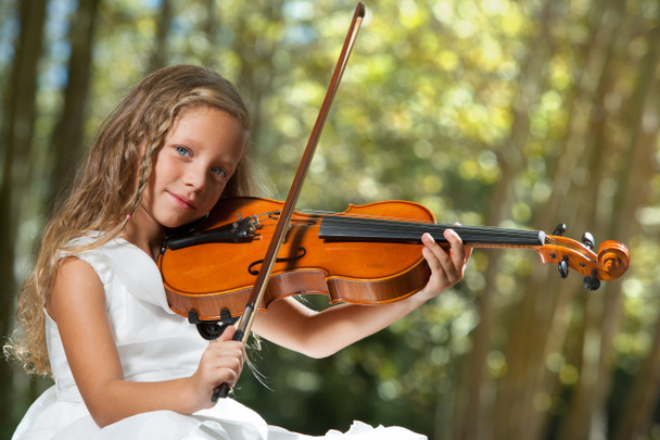Close-up van portret van jonge violist in bos. - Foto, afbeelding