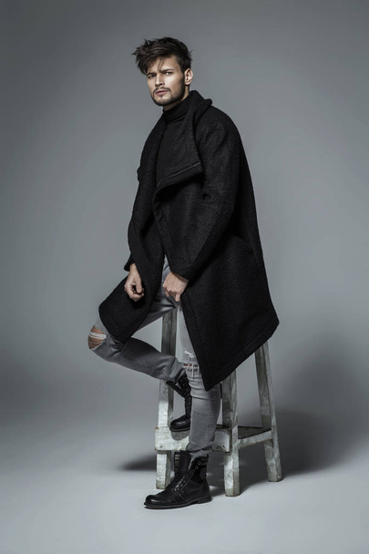 Handsome model in black long coat - Фото, изображение