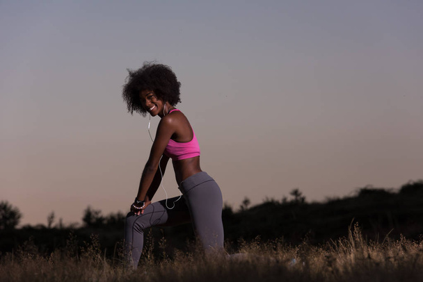black woman is doing stretching exercise relaxing and warm up - Photo, image