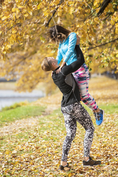 Beautiful young couple enjoying together in the park. Autumn environment. - Foto, Imagem