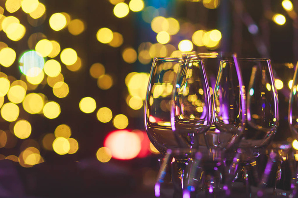 Beautiful row line of different colored alcohol cocktails on a party, martini, vodka,and others on decorated catering bouquet table on open air event, picture with beautiful bokeh - 写真・画像