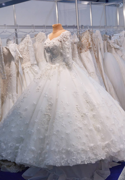 Elegant wedding dresses hanging in a store - Photo, Image