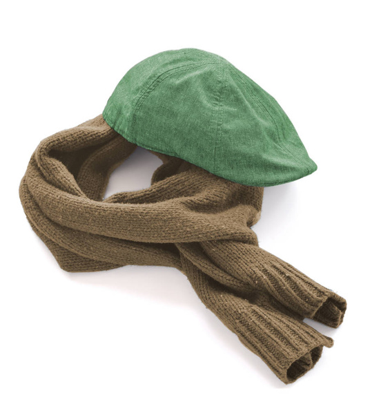 Green cap and brown warm scarf on a white background - Фото, зображення