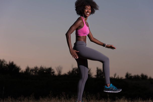 black woman is doing stretching exercise relaxing and warm up - Foto, imagen