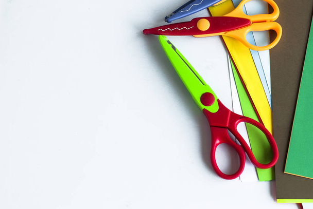 Children's creative tools. curly scissors and colored sheets - Фото, изображение