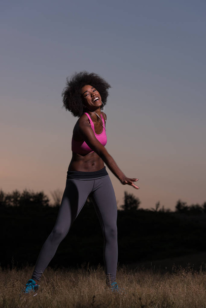 black woman is doing stretching exercise relaxing and warm up - Foto, Bild